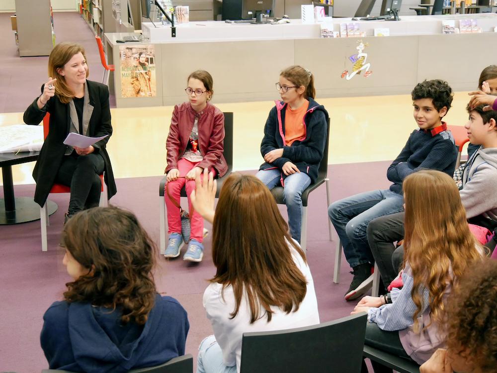 Fanny and the children discussing in a circle