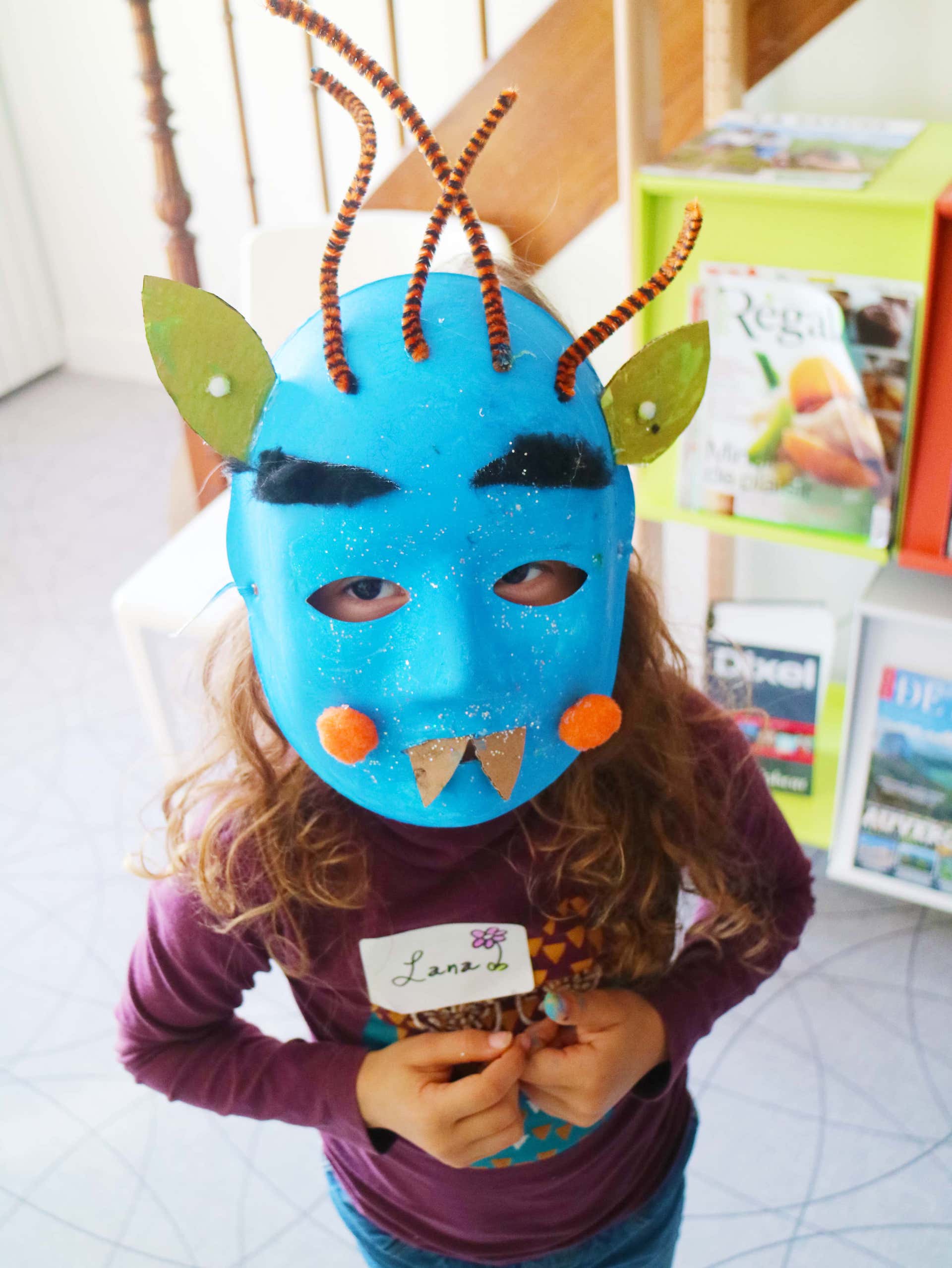 A child with a blue monster mask
